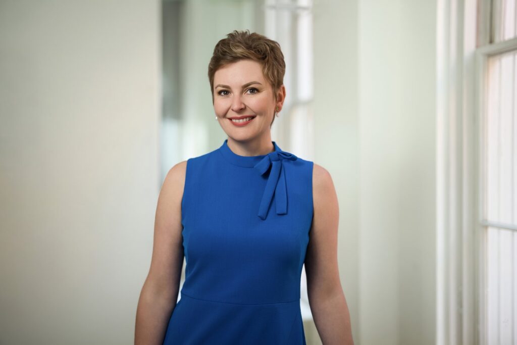 Professional woman posing for a personal branding headshot in a Washington DC office