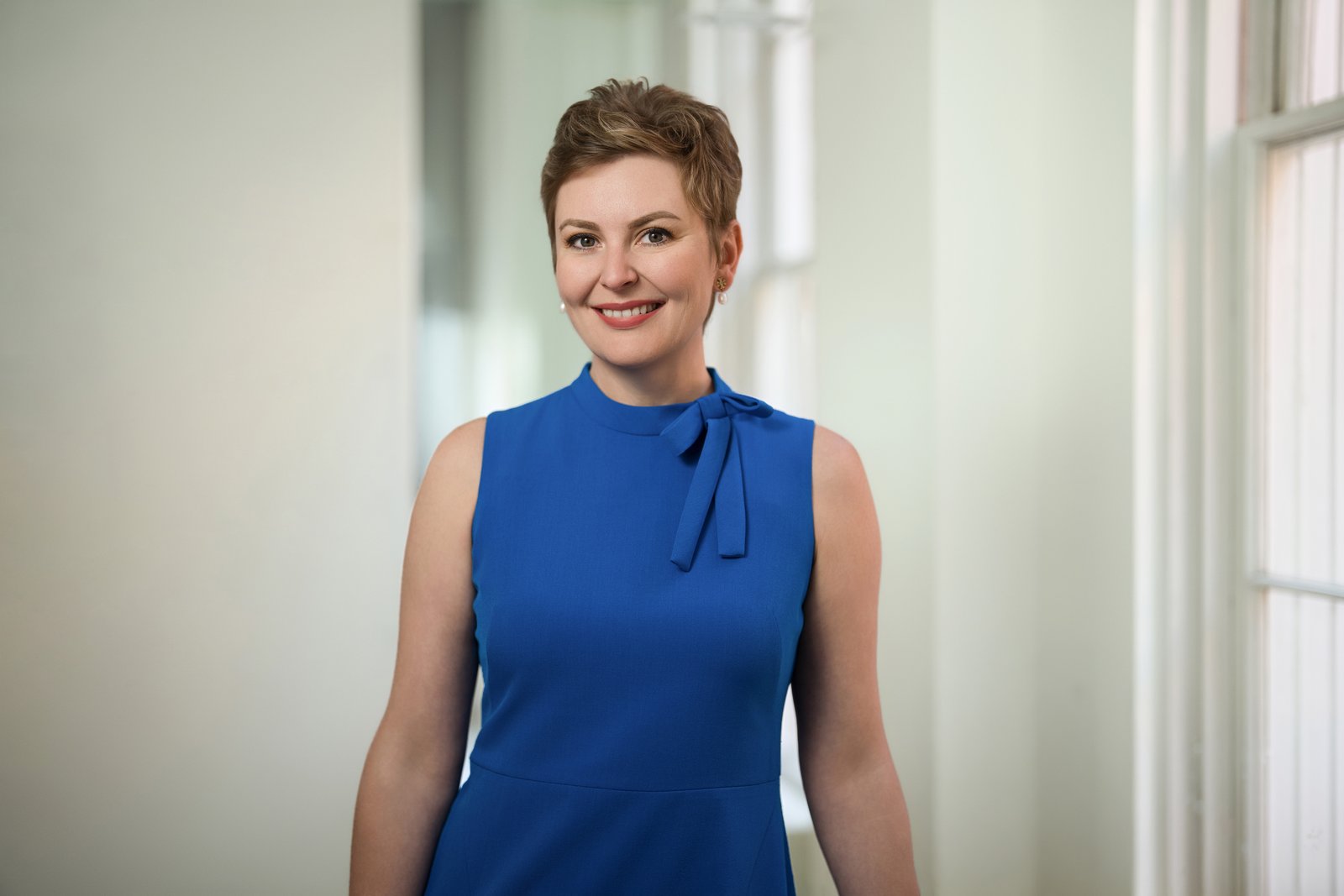 Professional woman posing for a personal branding headshot in a Washington DC office