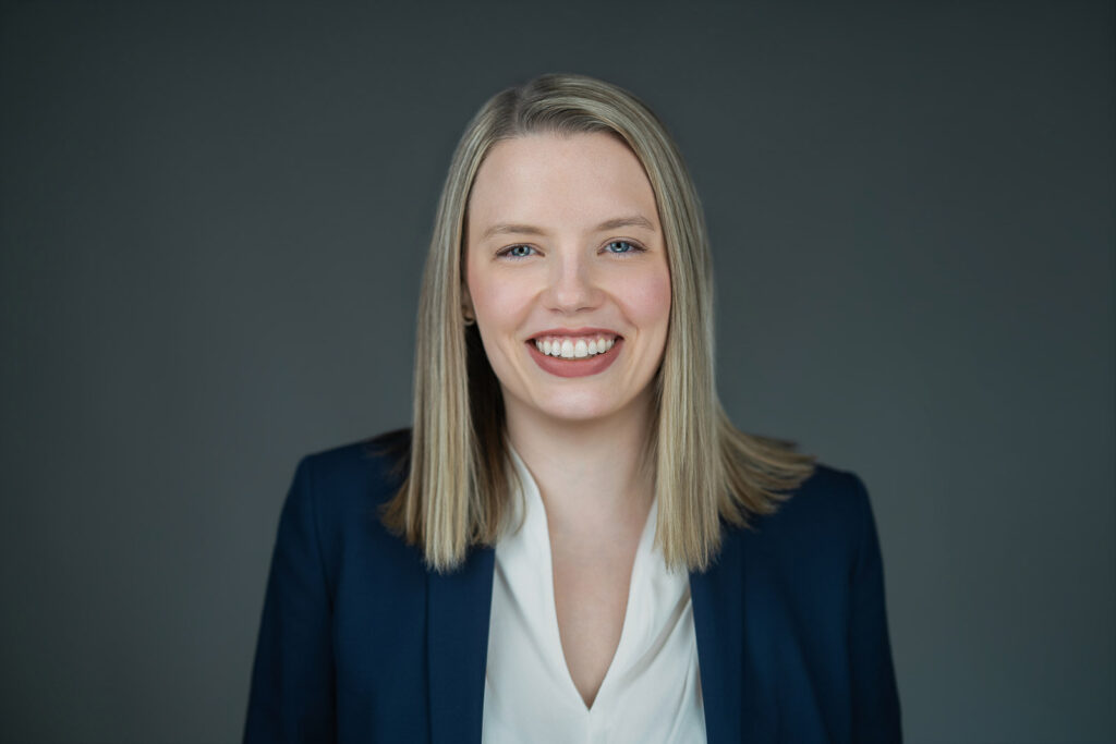 Business professional smiling warmly during a professional headshot session in New Milford, NJ