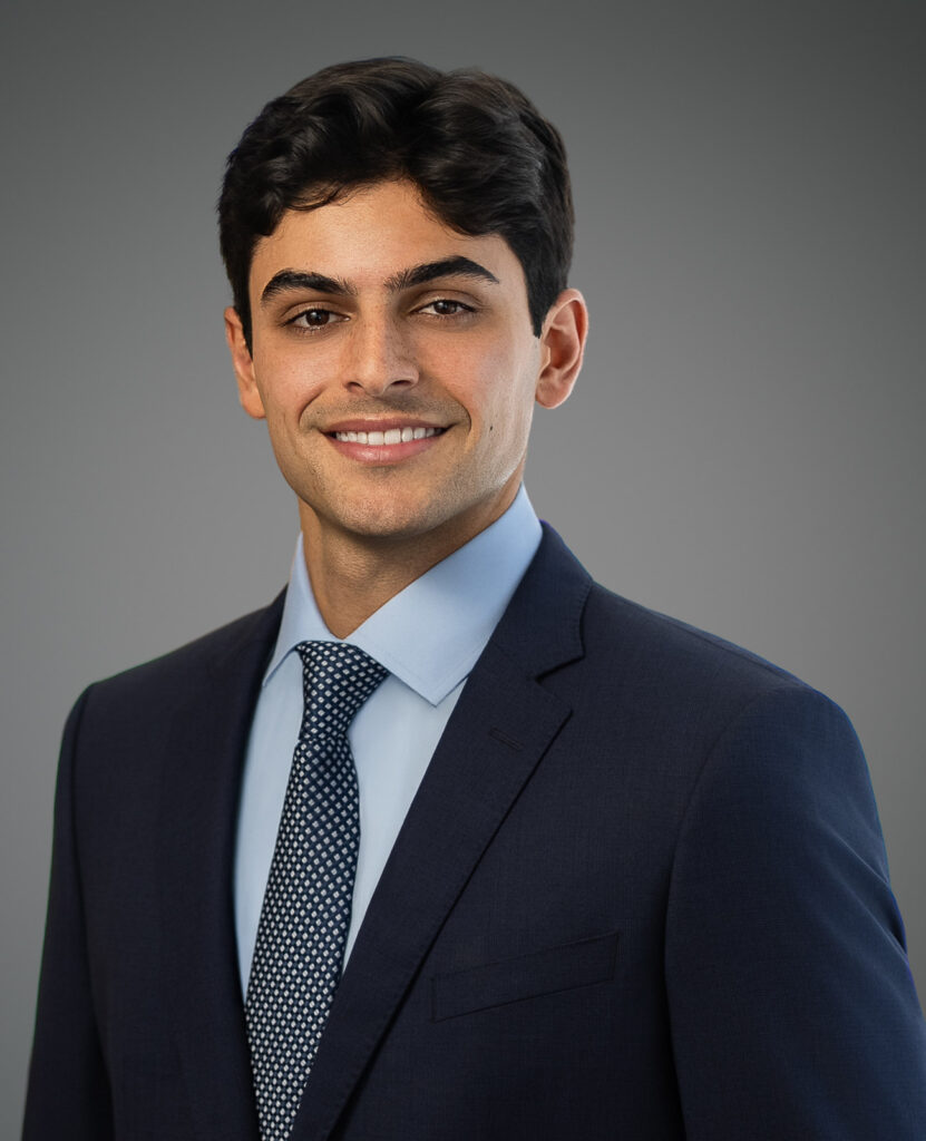 Young professional in a navy suit smiling for a professional headshot in New Jersey