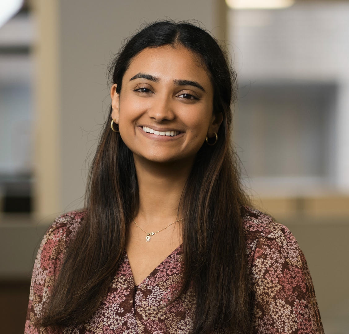 Young professional posing for a professional headshot in a modern New Jersey office