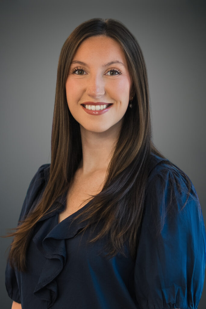 Professional smiles in navy blouse for business casual headshot in Northern New Jersey