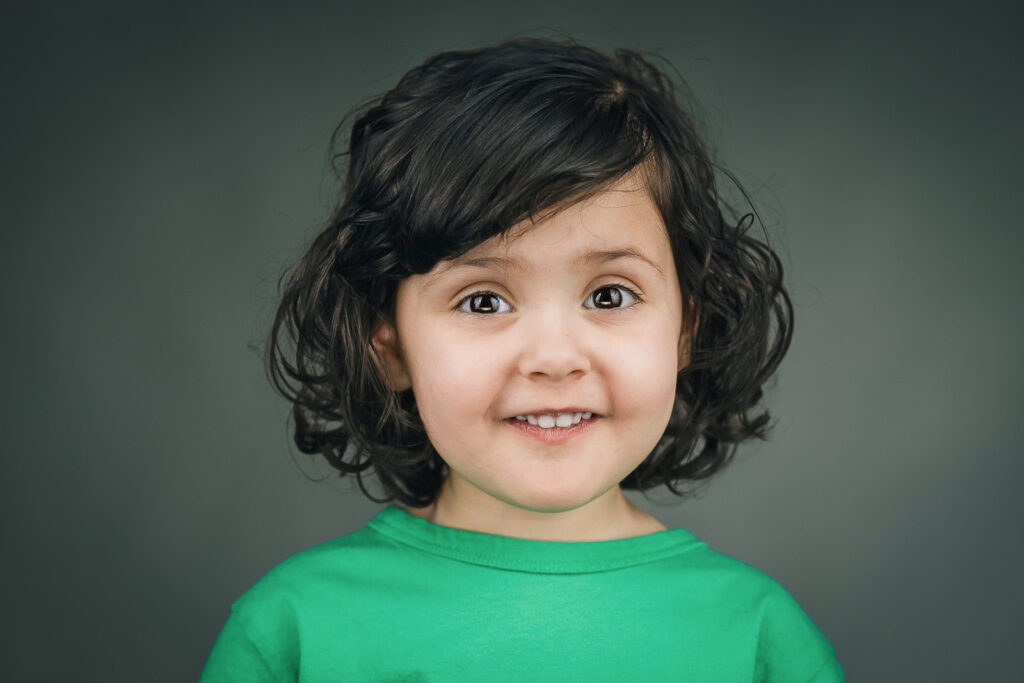 Child actor smiling naturally during a headshot session in New Jersey
