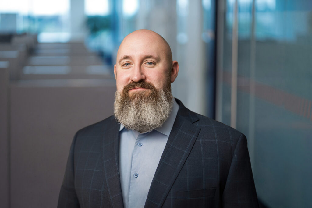Senior team member photographed in available light at a Long Island engineering office