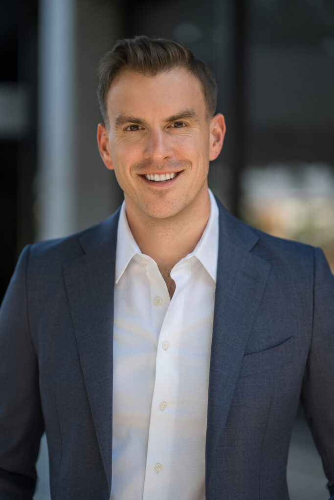 Financial advisor smiling during an outdoor executive headshot session in Hackensack, New Jersey