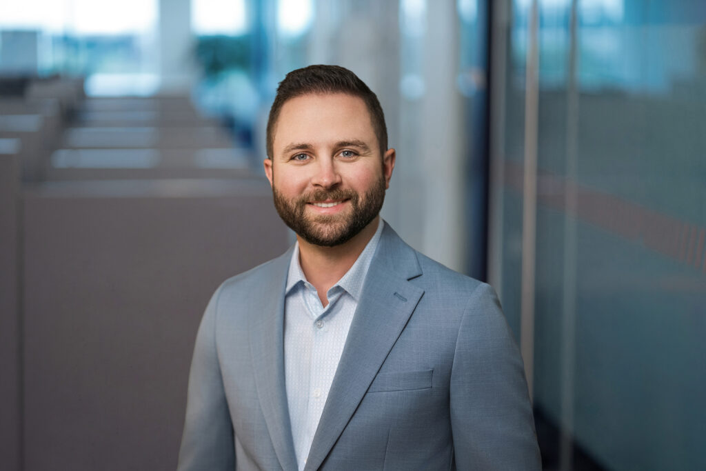 Employee photographed in window light during a Long Island office headshot session