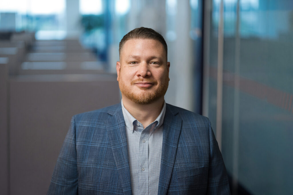 Business professional photographed during on-location corporate headshots at a Long Island office