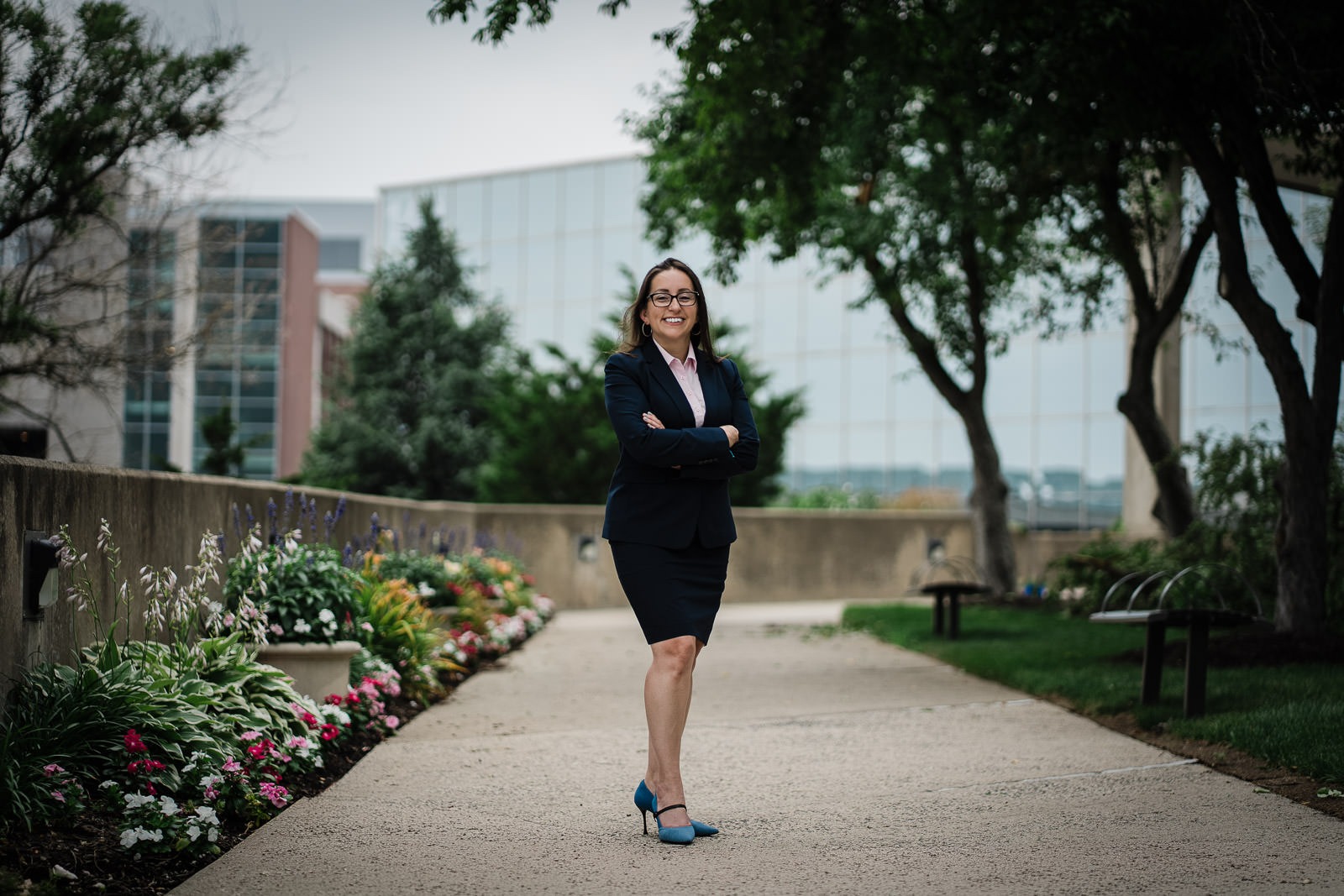 Business professional standing outside a corporate campus during an outdoor headshot session in New Jersey