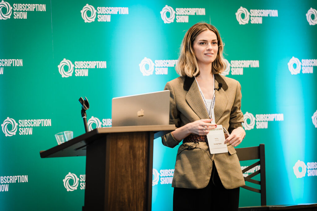 Speaker presenting beside Subscription Show branding in Jersey City