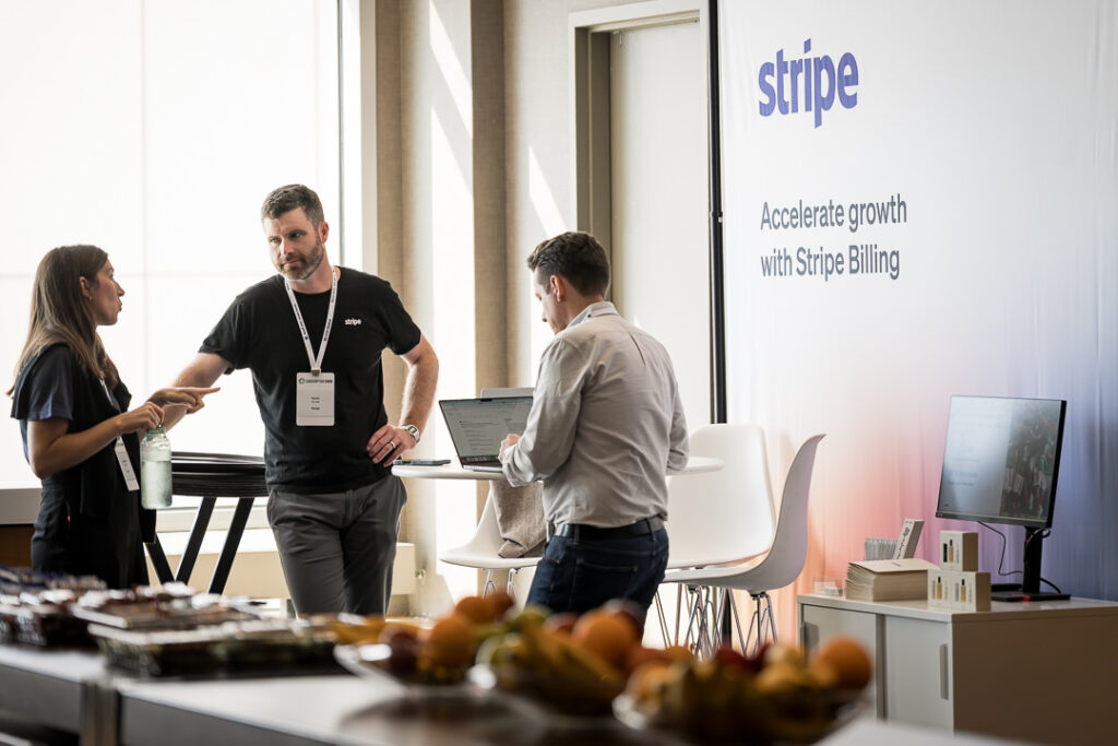 Attendees speaking at the Stripe sponsor booth during Subscription Show 2025 in Jersey City