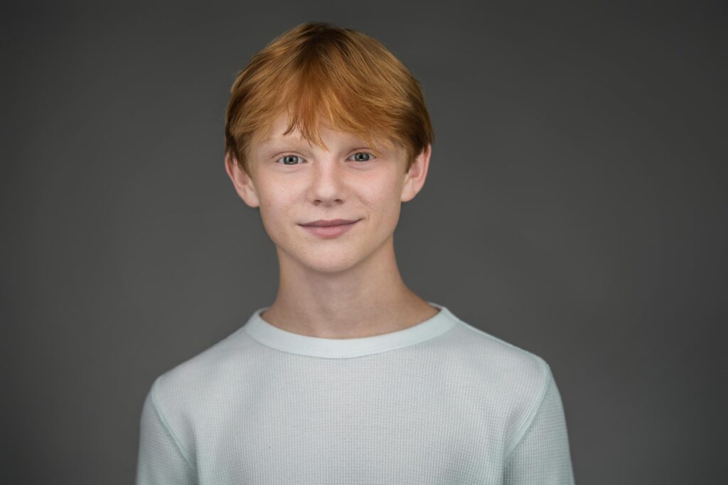 Young actor holding a composed expression in waffle knit top during New Milford NJ headshot session