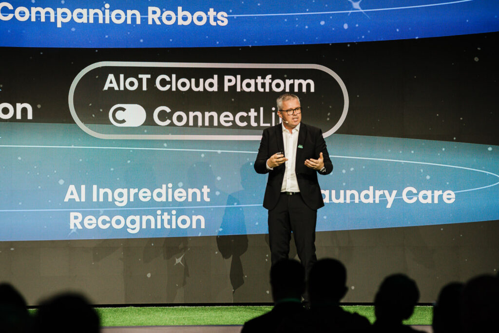 Speaker presenting artificial intelligence topics on stage at The Glasshouse