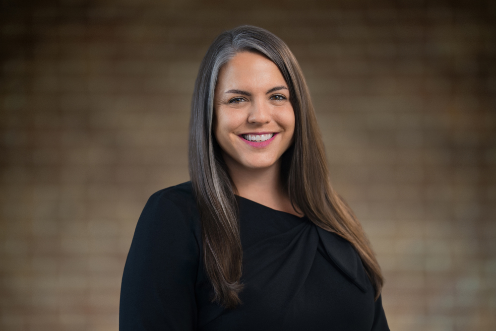 Professional headshot showing a consistent blurred background across a corporate team session