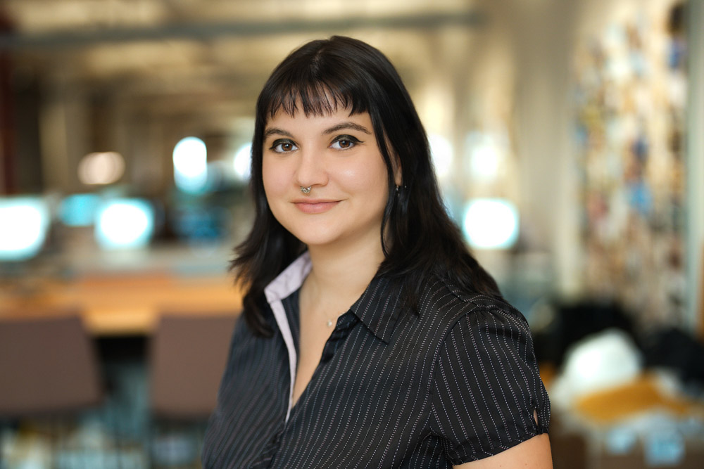 Employee in a pinstripe shirt photographed inside a New York City office