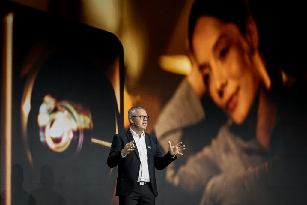 Speaker delivering a keynote presentation on stage at The Glasshouse in New York