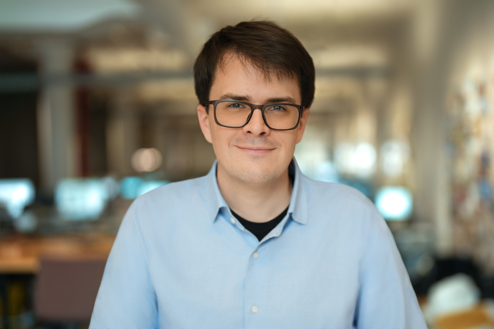 Employee in a light blue shirt and glasses photographed inside a New York City office
