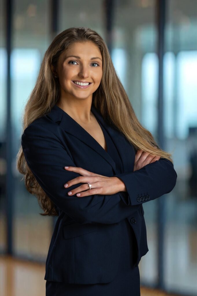 Female professional standing with confident posture during an executive portrait session in a Northern NJ office