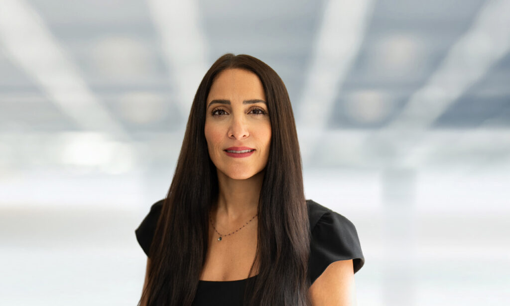 Law firm partner photographed for executive branding against a softly blurred office background