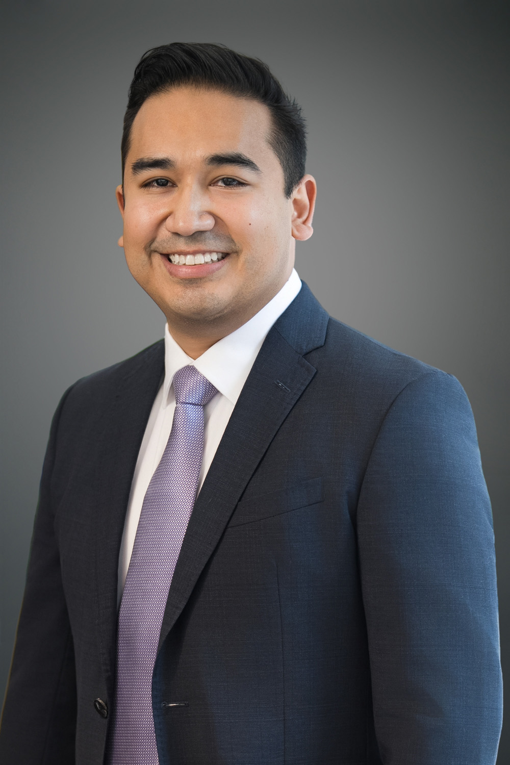 Executive smiling confidently during a professional headshot session in a New Jersey studio