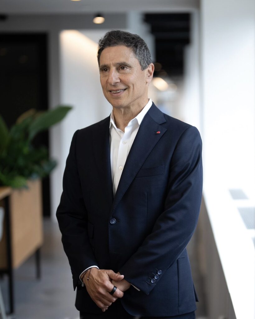 Business executive with a subtle smile during a professional headshot session in an office