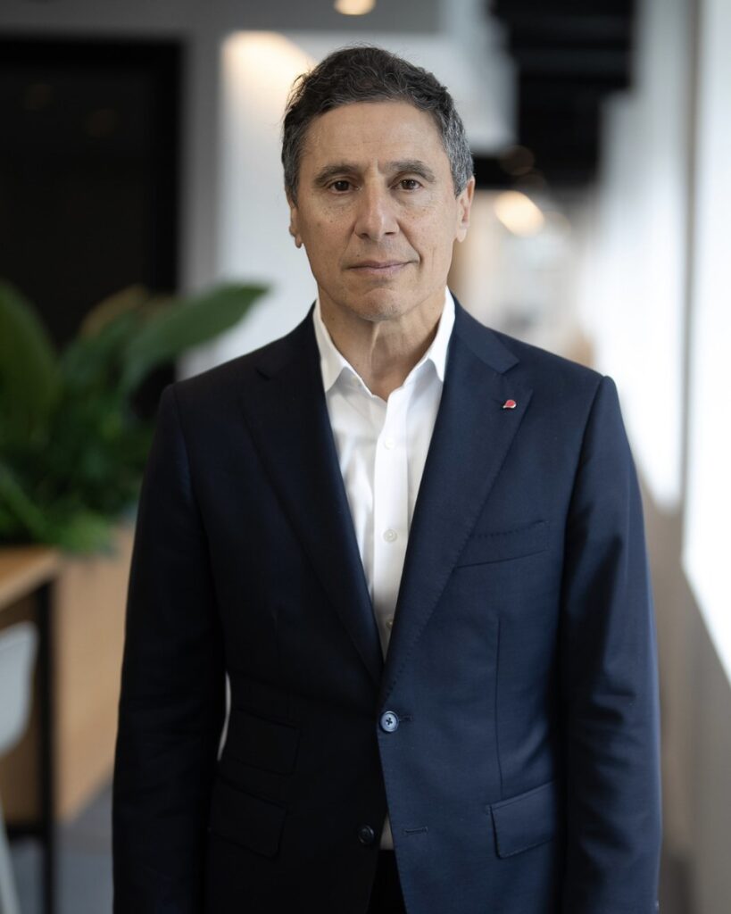 Business executive with a composed neutral expression during a professional headshot session in an office