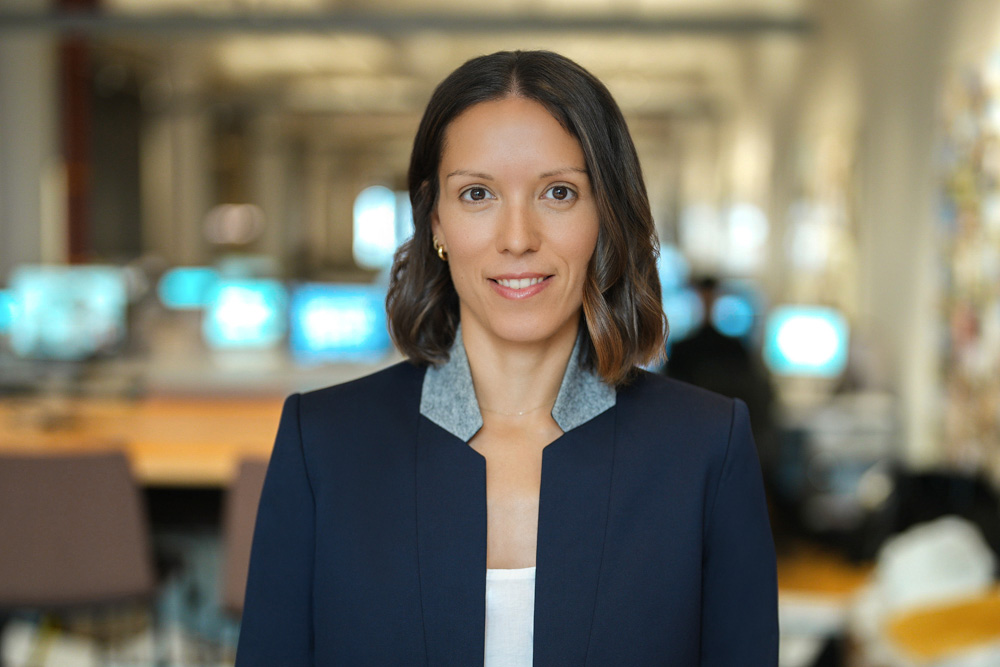 Professional in a navy blazer photographed inside a New York City office