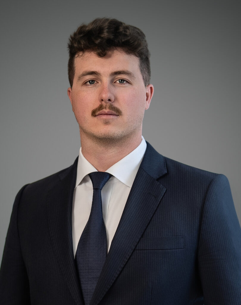 Male professional photographed with a composed, confident expression during a professional headshot session