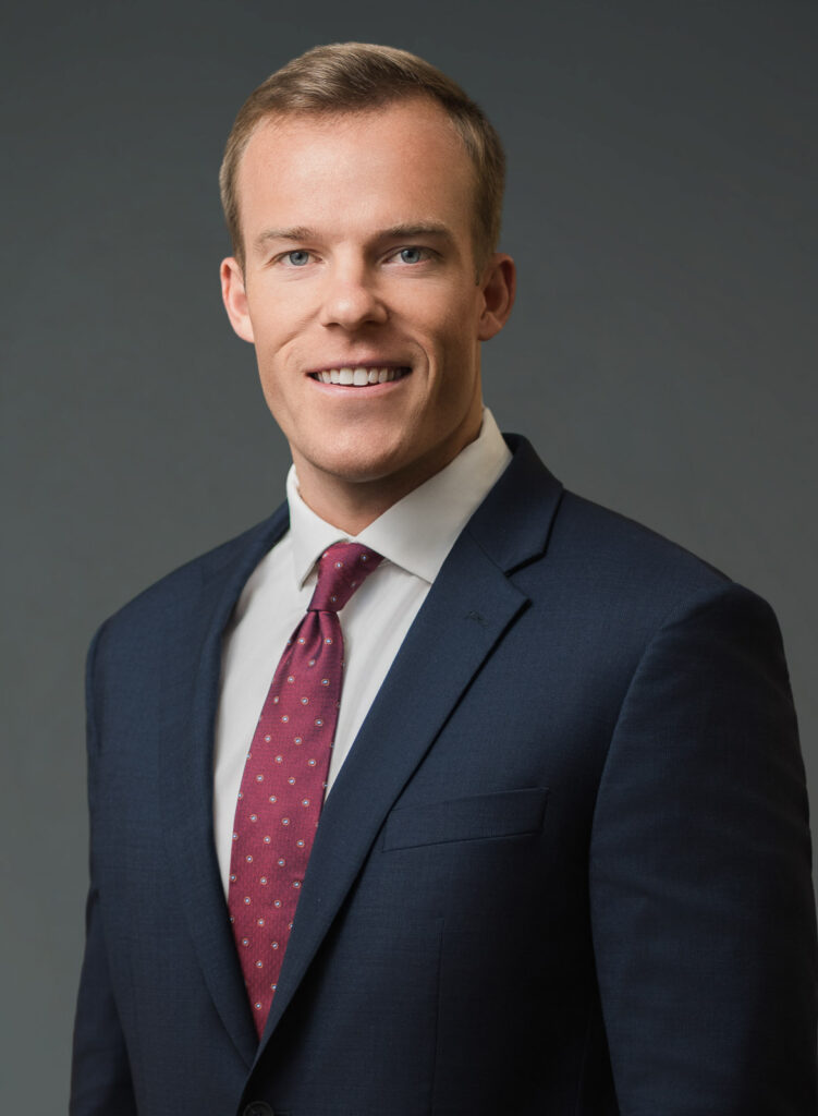 Male professional in navy suit photographed in a traditional headshot crop at a Northern NJ studio