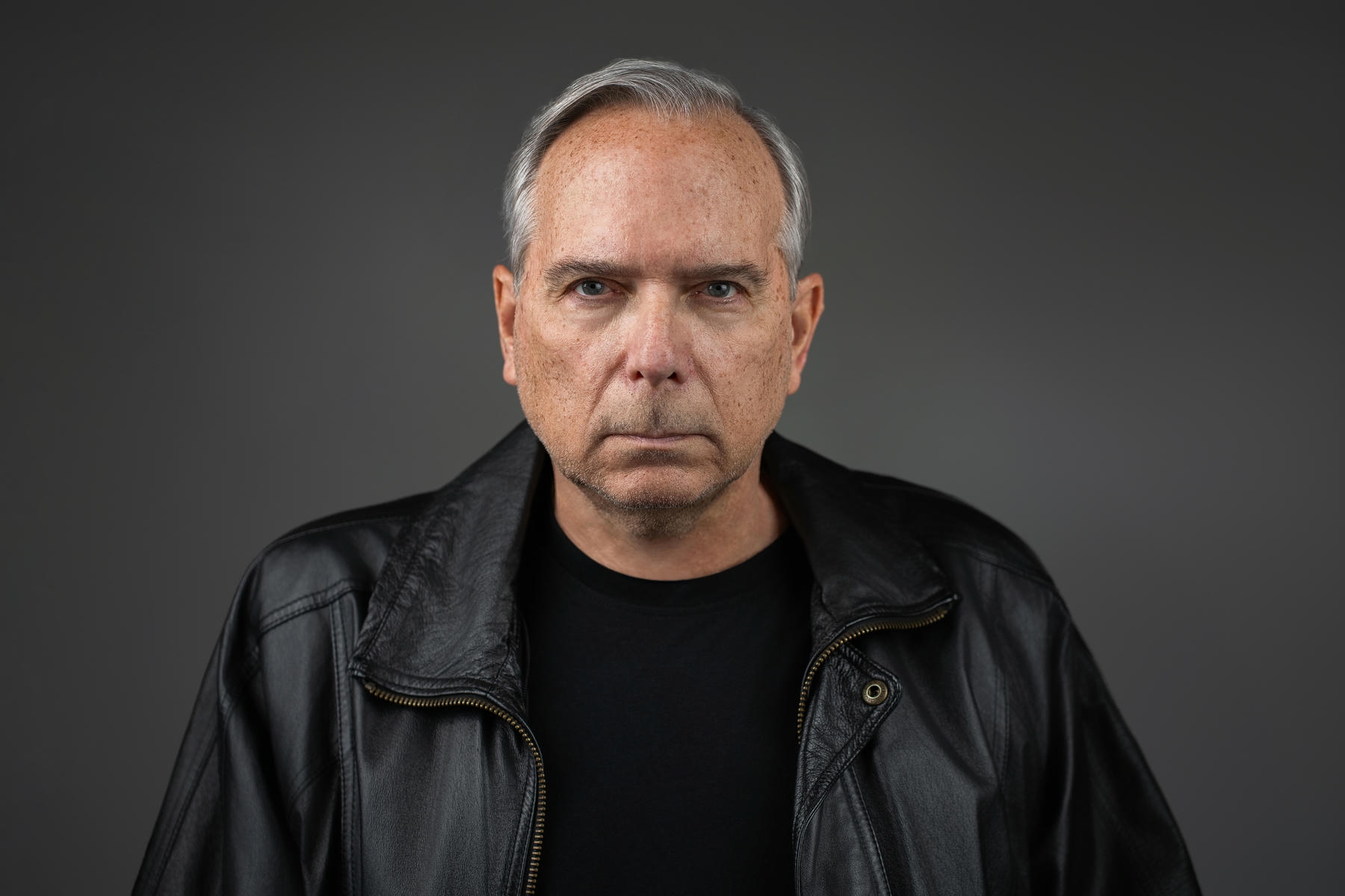 Actor in leather jacket photographed for principal role headshots at New Milford NJ studio