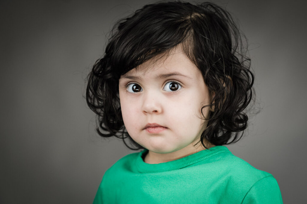  Two child actor headshots from one session, one guarded and one laughing