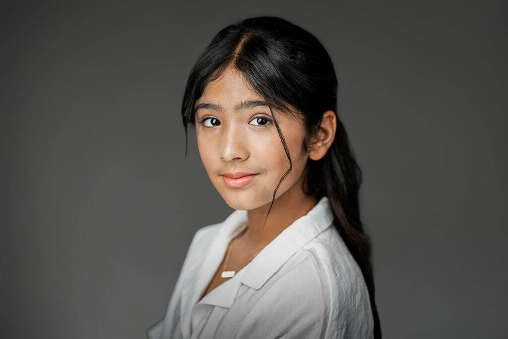 Tween actor turning toward camera during a child acting headshot session in New Milford NJ