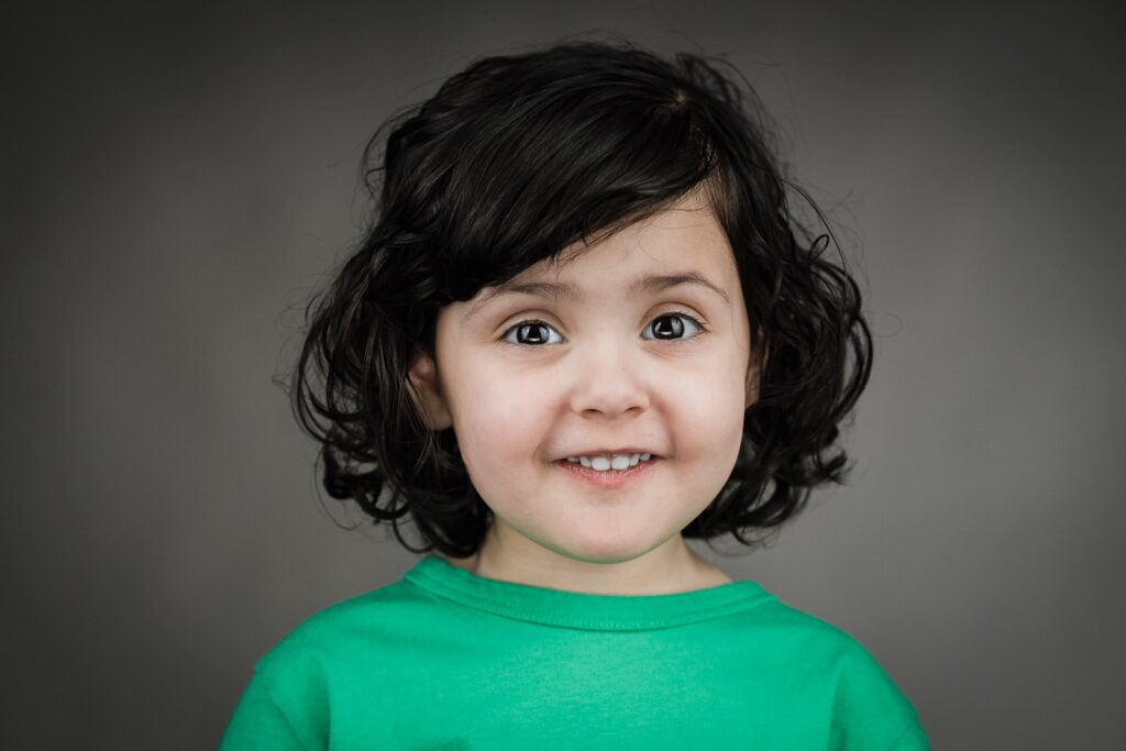Toddler in a green shirt during a kids acting headshot session in New Jersey