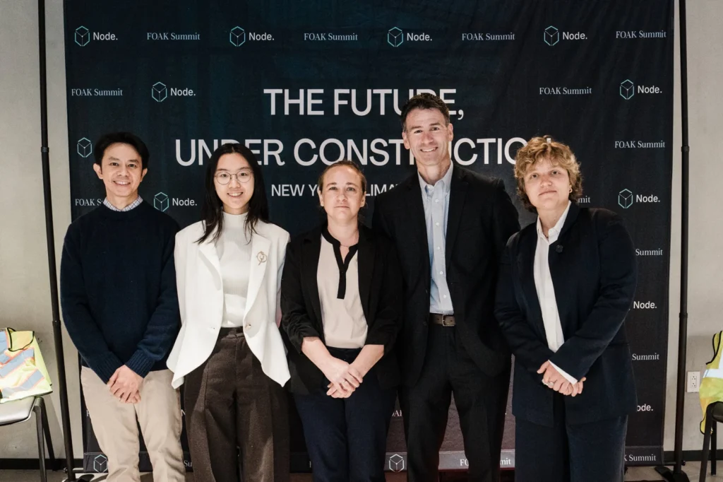 Attendees posing in front of the New York Climate Week backdrop at the FOAK Summit
