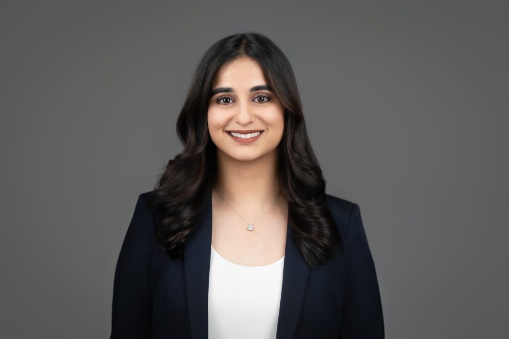 Smiling woman in navy blazer posing for ERAS style headshot in New Jersey studio