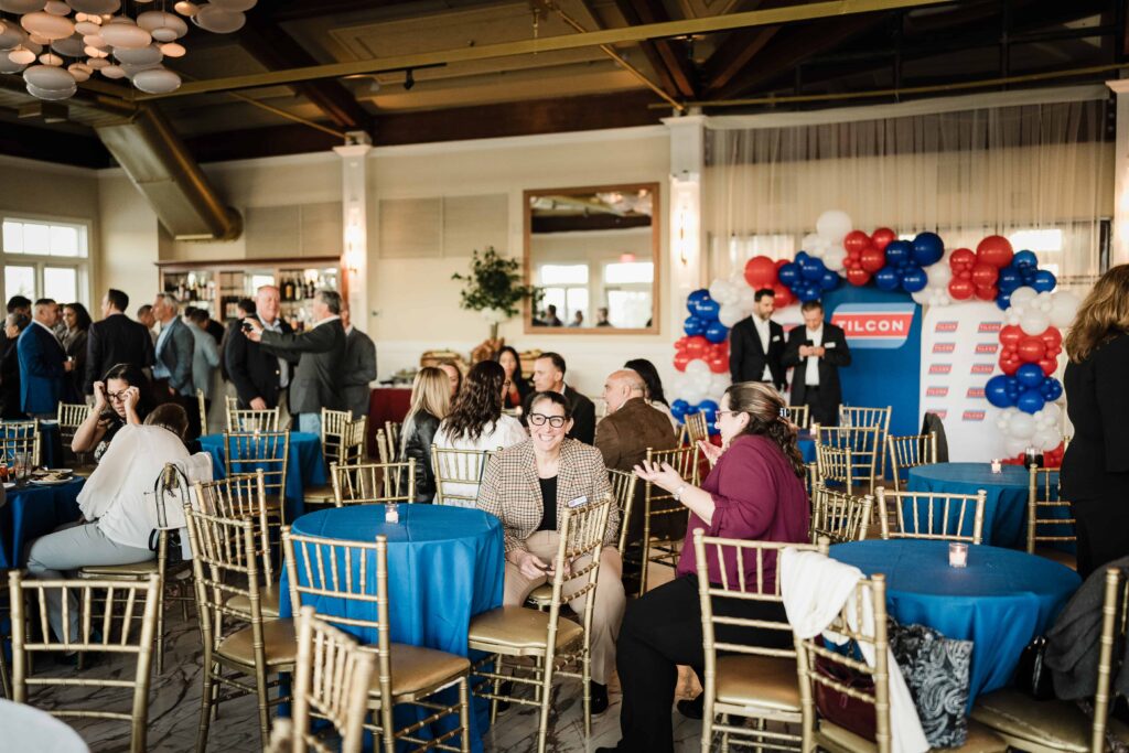 Guests mingling at blue-draped tables in the reception room at Liberty House in Jersey City