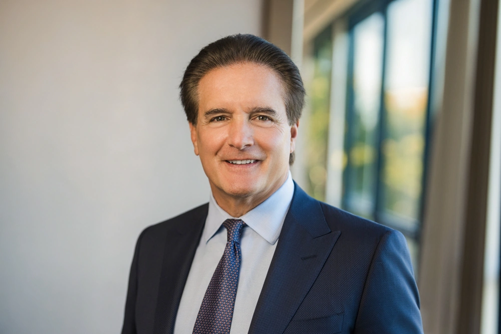 Male financial advisor wearing a navy suit and tie for a professional headshot