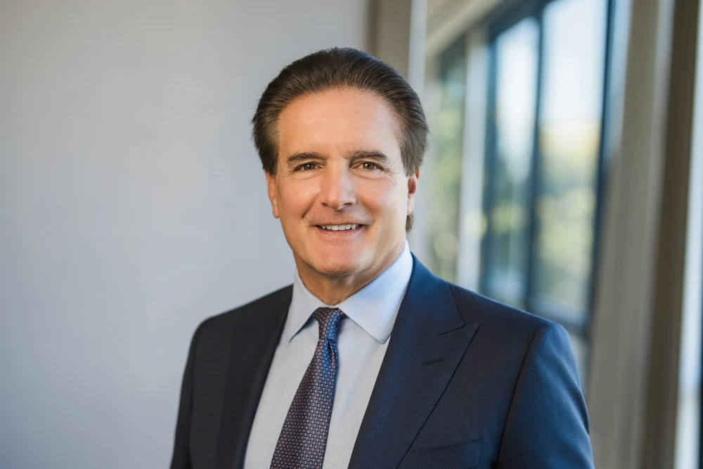 Male financial advisor wearing a navy suit and tie for a professional headshot