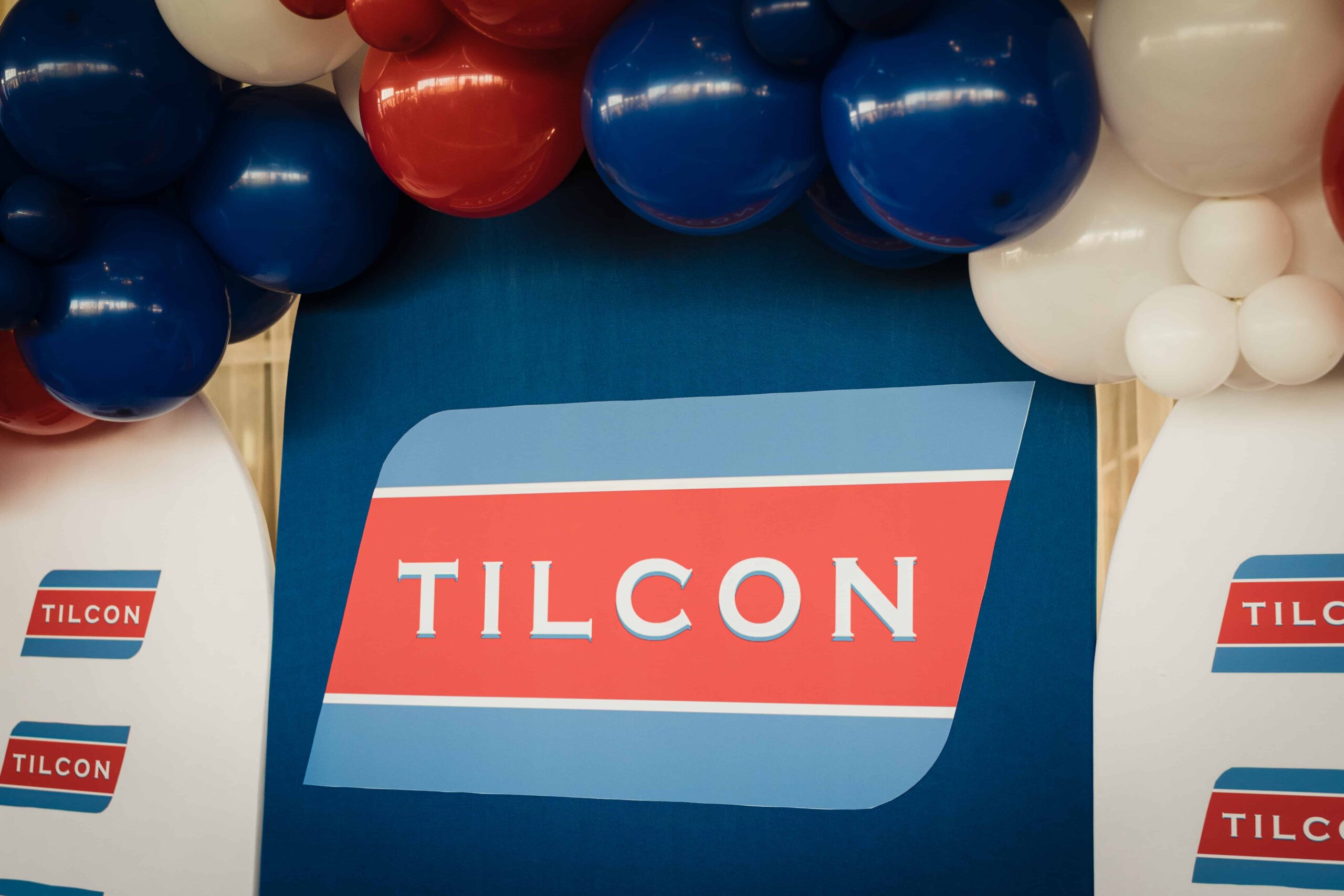 Tilcon logo beneath red, white and blue balloons at the Tilcon New York corporate event at Liberty House