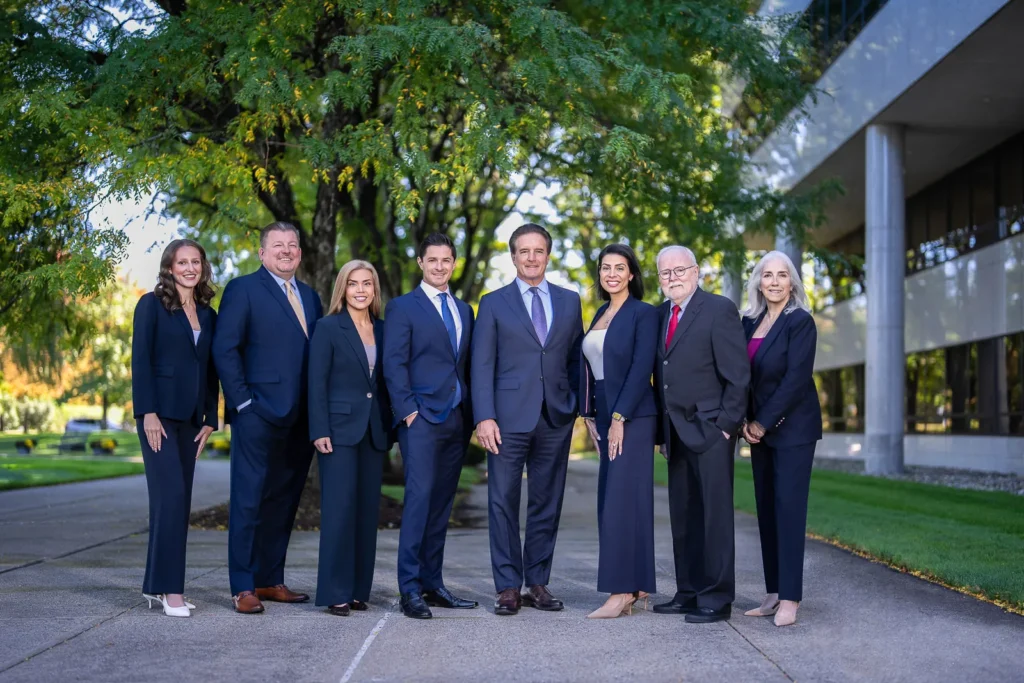 Financial advisory team in business attire photographed together outdoors